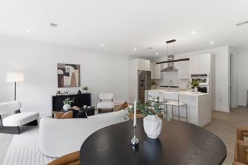 Westfield apartment for rent - A modern living room with a black table and white furniture.