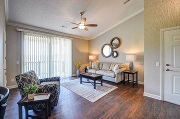 Akron apartment for rent - a living room with a couch and a chair and a ceiling fan
