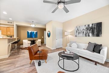 Akron apartment for rent - a living room with a white couch and a ceiling fan