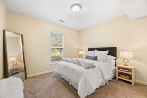 Akron apartment for rent - a bedroom with a large bed and a mirror
