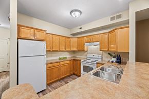 Akron apartment for rent - a kitchen with white appliances and wooden cabinets