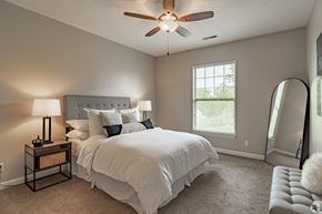 Akron apartment for rent - a bedroom with a large bed and a ceiling fan