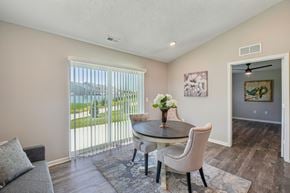 Whitmore Lake apartment for rent - A dining room with a table and chairs and a painting on the wall.