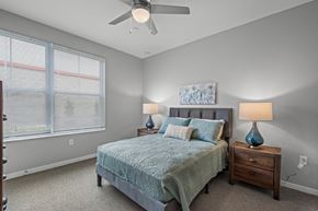 Columbus apartment for rent - a bedroom with a bed and a ceiling fan