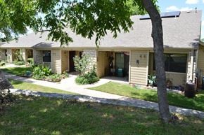 Austin apartment for rent - A tree is in front of a house.