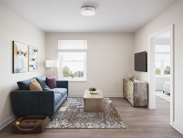 Macedonia apartment for rent - A living room with a blue couch and a rug.