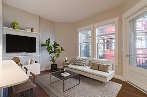 Cincinnati apartment for rent - A living room with a white couch, a coffee table, and a flat screen TV.