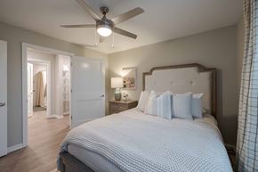 Columbus apartment for rent - A bedroom with a large bed and a ceiling fan.