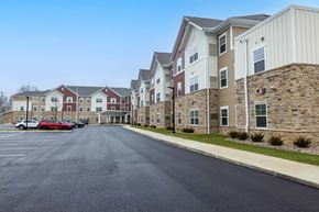 Columbus apartment for rent - A parking lot in front of a row of apartment buildings.