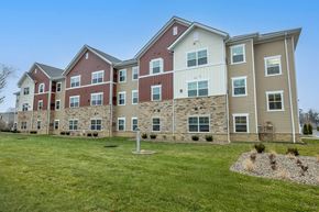 Columbus apartment for rent - A large apartment complex with multiple buildings and a grassy front yard.