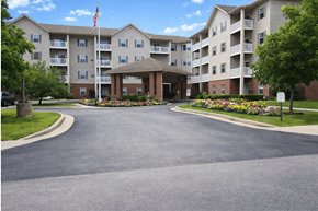 Fort Wayne apartment for rent - A large apartment complex with a flag flying in front.