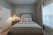 Union City apartment for rent - A bedroom with a large bed and a nightstand with a lamp.