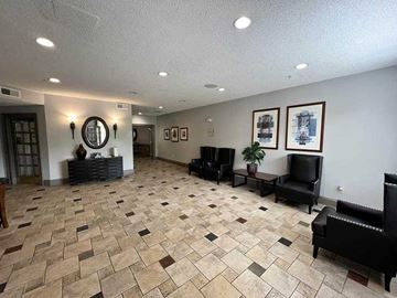 Atlanta apartment for rent - A living room with a black couch and a mirror on the wall.
