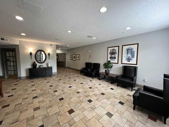 Atlanta apartment for rent - A living room with a black couch and a mirror on the wall.