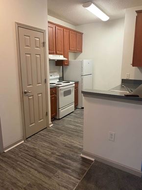 Atlanta apartment for rent - A kitchen with a white refrigerator and white stove.