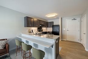 Hebron apartment for rent - A kitchen with a white countertop and green barstools.
