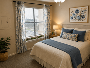 San Antonio apartment for rent - A bedroom with a large bed and a window with curtains.