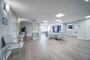 Phoenix apartment for rent - A spacious waiting room with white chairs and a plant.