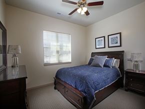 Lithonia apartment for rent - A bedroom with a bed, nightstands, and a ceiling fan.