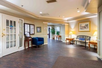 Cincinnati apartment for rent - A spacious living room with a blue sofa and wooden floors.