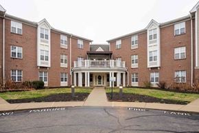 Cincinnati apartment for rent - A brick building with a white entrance and a sign that says "No Parking".