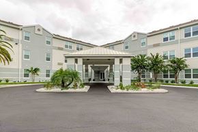 Fort Myers apartment for rent - A large building with a courtyard in front of it.