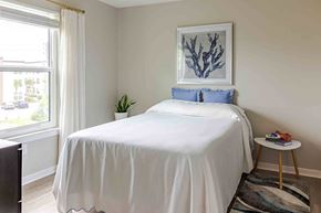 Fort Myers apartment for rent - A bedroom with a white bed and a blue pillow.