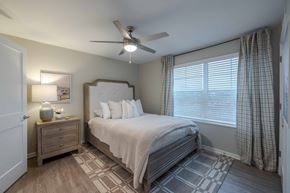 Kalamazoo apartment for rent - A bedroom with a bed, nightstand, and window.