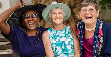 Terre Haute apartment for rent - Three women are laughing together in front of a tree.