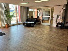 Charleston apartment for rent - A room with wooden flooring and a black couch.