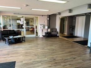 Charleston apartment for rent - A room with wooden floors and a black couch.