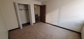 Charleston apartment for rent - A room with a brown carpet and a white wall with a closet.