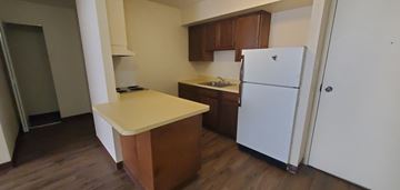Charleston apartment for rent - A kitchen with a white refrigerator and wooden cabinets.