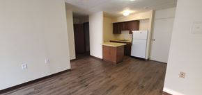 Charleston apartment for rent - A kitchen with white appliances and wooden floors.