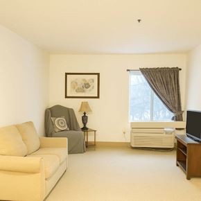 Sistersville apartment for rent - A living room with a couch, chair, and television.