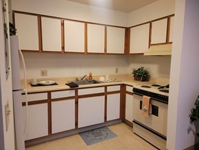 Sistersville apartment for rent - A kitchen with white cabinets and a white refrigerator.