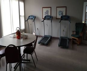 Wilkinsburg apartment for rent - A room with a table, chairs and exercise equipment.