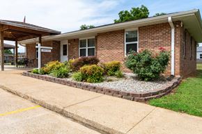 Doniphan apartment for rent - A small brick building with a porch and a sign that says "OFFICE" on it.