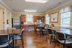 Doniphan apartment for rent - A kitchen with a table and chairs in the foreground and a refrigerator in the background.