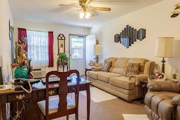 Doniphan apartment for rent - A living room with a tan couch and a wooden table.