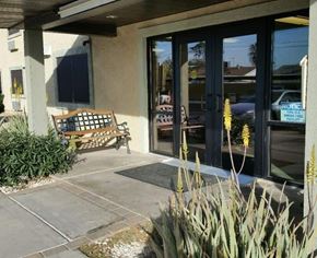 Glendale apartment for rent - A bench is placed outside a building with glass doors.