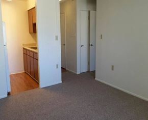 Glendale apartment for rent - A room with a carpeted floor and white walls.
