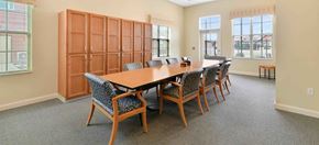 Dublin apartment for rent - Conference room with large table and upholstered chairs at Avondale Senior Village Apartments, Dublin, Ohio