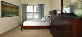 Dublin apartment for rent - A bedroom with a bed, dresser and a painting on the wall.