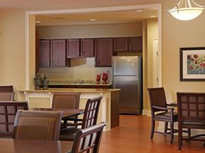Atlanta apartment for rent - A kitchen with brown chairs and a refrigerator.