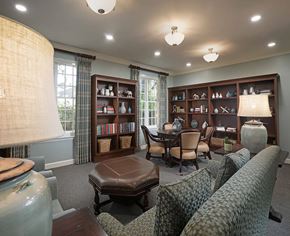 Savannah apartment for rent - A living room with a couch, ottoman, and bookshelves.