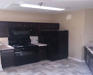 Savannah apartment for rent - A kitchen with black appliances and cabinets.