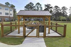 Pembroke apartment for rent - A wooden gazebo with a metal roof is surrounded by a fence and has a sign on it.