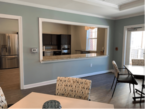 Pembroke apartment for rent - A kitchen with a table and chairs in front of a window.