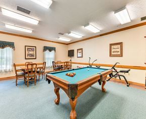 Middletown apartment for rent - A pool table is in the middle of a room with chairs and pictures on the wall.